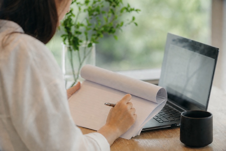 A compliance reviewer examining a printed audit record